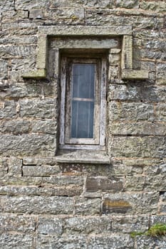 An old brick building with a crooked window