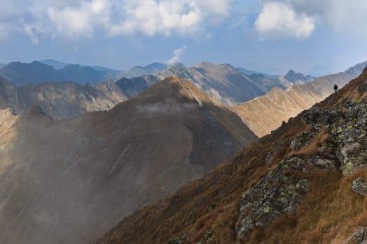 rows of mountains and a sky with clouds, Fagaras mountains, Romania