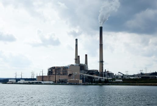 Coal fueled electricity power station by the side of a lake