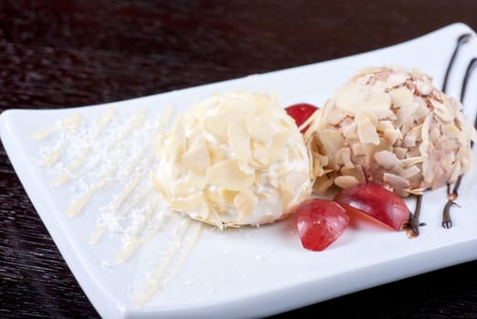 Dessert set of ice-cream with almond, chocolate and grapes
