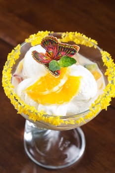 Ice cream dessert with kiwi and orange decorated with butterfly