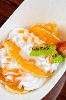 Ice cream dessert with kiwi, strawberry and orange