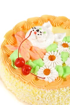 cream cake closeup with cherry on a grey