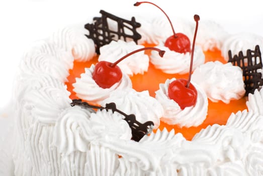 cream cake closeup with cherry on a grey