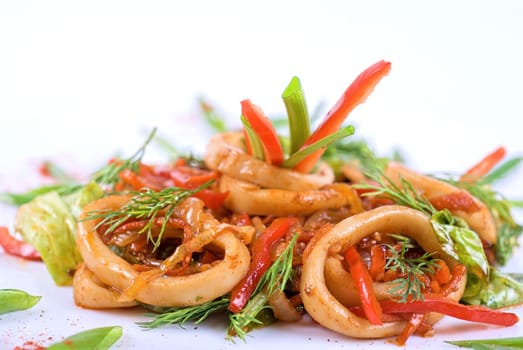Seafood salad with squid and vegetables closeup