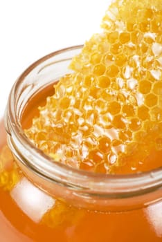 jar of organic honey on white background