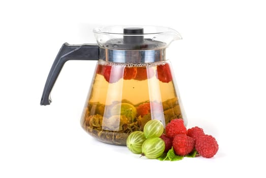 Teapot with fruit tea and berries on a white background