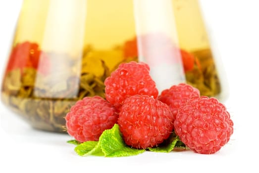 Teapot with fruit tea and berries on a white background