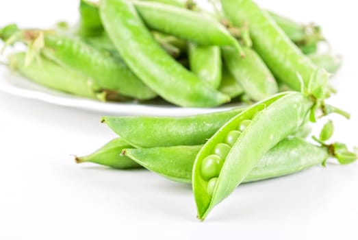 Ripe pea vegetable with green leaf isolated on white background