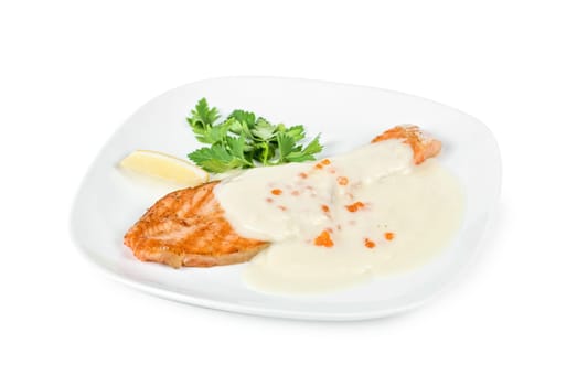Grilled salmon steak with cheese sauce, greens, lemon and red caviar