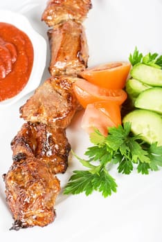 Fried kebab meat with vegetables and sauce
