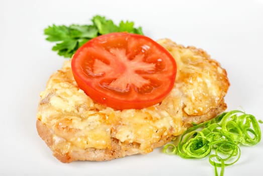 Roasted pork steak baked with cheese and tomato