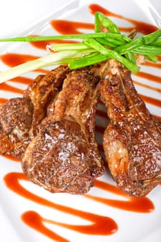 Roasted lamb meat tied with scallion closeup