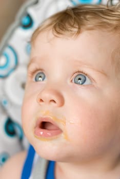 Messy smiling baby boy after eating
