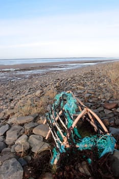 a lobster pot on a rocky irish beach on the west coast