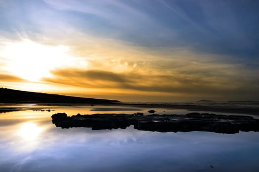 mud and rocks on beale beach co kerry ireland on a beautiful cold winters day