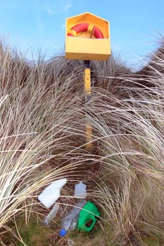 rubbish next to a beach lifebuoy