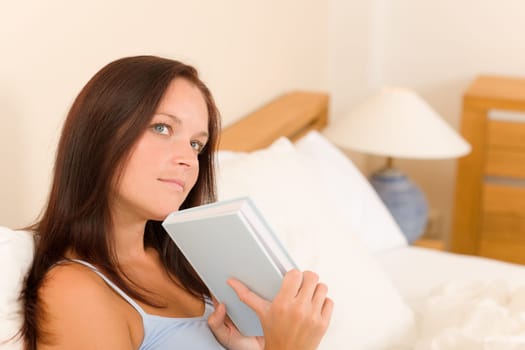 Bedroom thoughtful woman read book in white bed