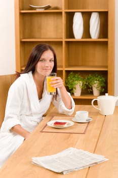 Breakfast orange juice and toast happy woman in home bathrobe