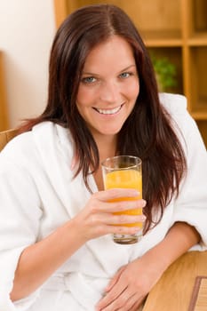 Breakfast - Smiling woman with fresh orange juice in modern interior