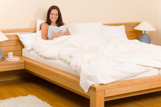 Bedroom - young woman read book in white bed