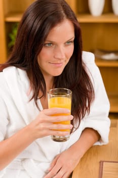 Breakfast - Smiling woman with fresh orange juice in modern interior