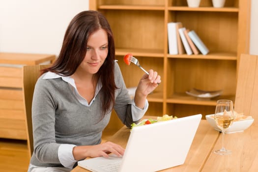 Working lunch at home attractive woman with laptop eat salad