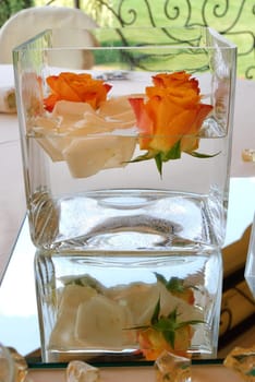 roses floating in a glass jar