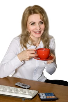 Businesswoman drinks coffee from a red cup at office