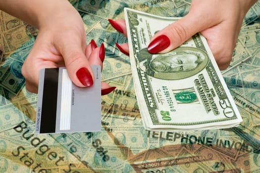 The female hand holds credit card and dollars