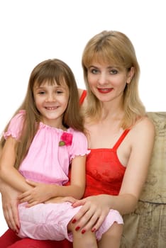 The daughter sits in a lap at mother and they smile