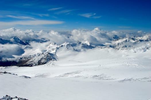 Snow-covered tops  on a background of the blue sky