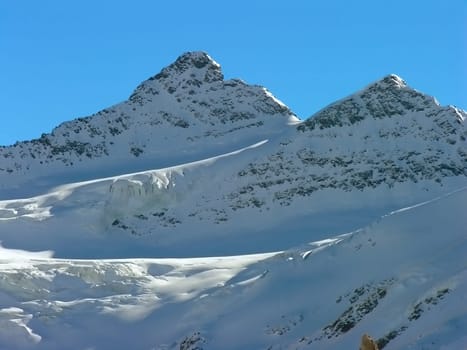 The mountain tops covered with a snow