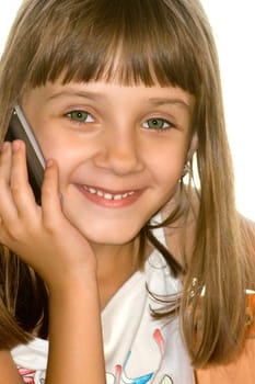 The girl talks by mobile phone