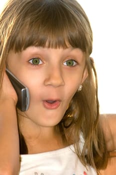 The girl talks by mobile phone