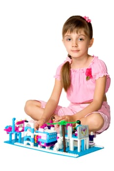The little girl playing with the meccano