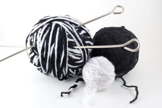 Three skeins of a wool and a knitting needles