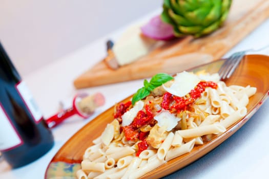 Closeup image of a pasta dish with sundried tomatoes and caramelized onions
