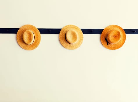 Shaker hats hanging on a peg rail