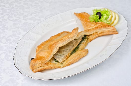 tasty dish of trout fish baked with greens at dough