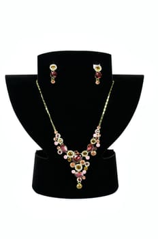 a necklace with pendants and earrings on a white background