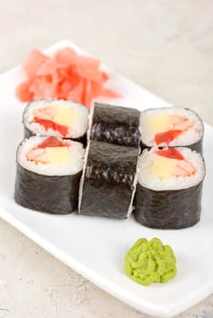 Sushi rolls made of crab meat, cheese, and tomato