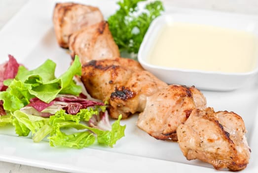 Fried kebab meat with vegetables and sauce