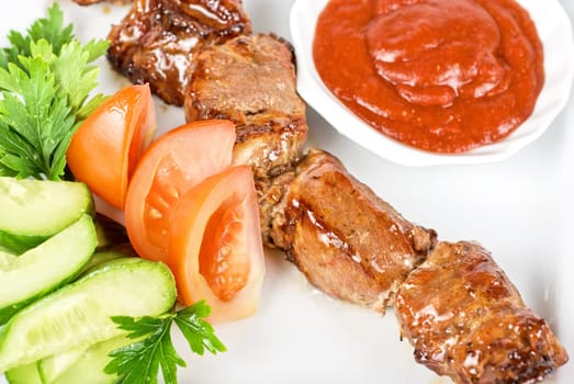 Fried kebab meat with vegetables and sauce