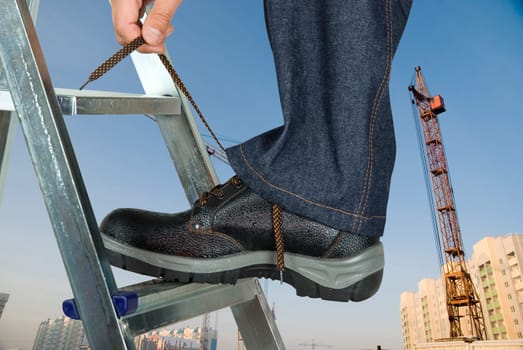 repairman lace his shoes on building background