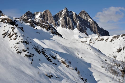 dolomites landscape with cliffs and snowy slopes, shot in bright winter light