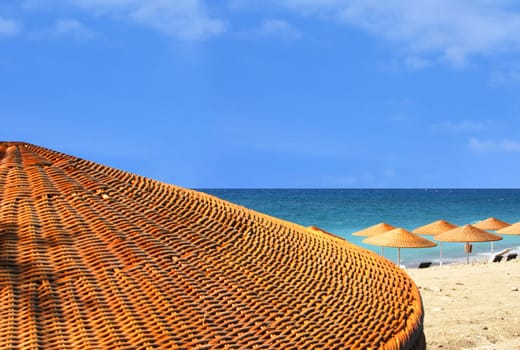 Sand beach view behind umbrella