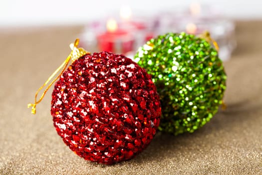 Close-up of sparkling Christmas baubles and candles