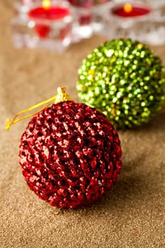 Close-up of sparkling Christmas baubles and candles