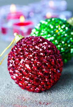 Close-up of sparkling Christmas baubles and candles